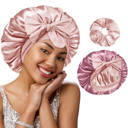 Woman wearing a pink satin bonnet with matching scrunchies on a white background